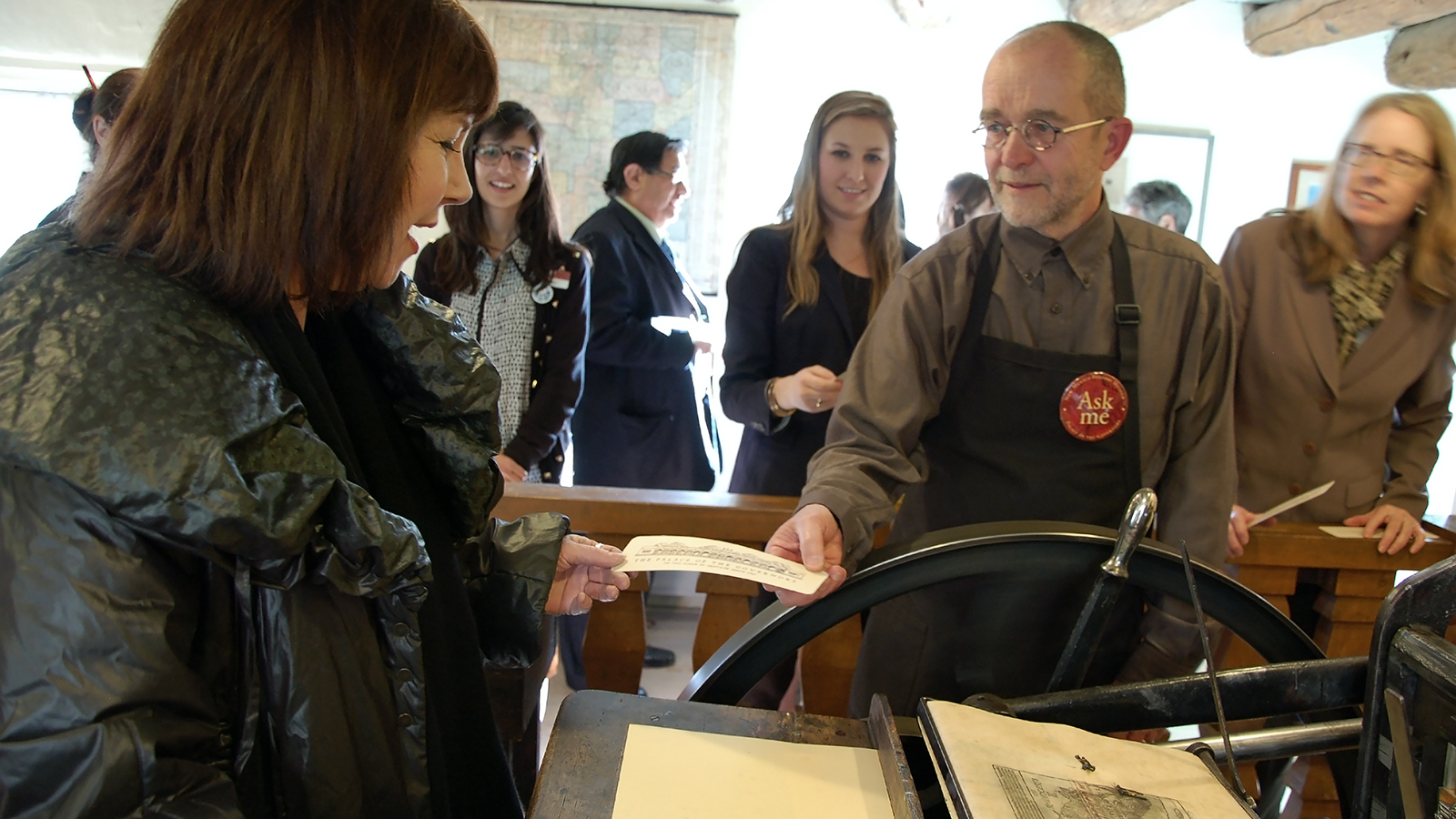 Curator Tom Leech assists in the printing of a souvenir impression of the Palace. Photo by Hannah Abelbeck